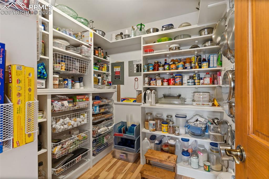 Image 24 of 45: Huge Walk-in Pantry w/Custom Shelves, Pull-out Baskets, & Peg Board to hold