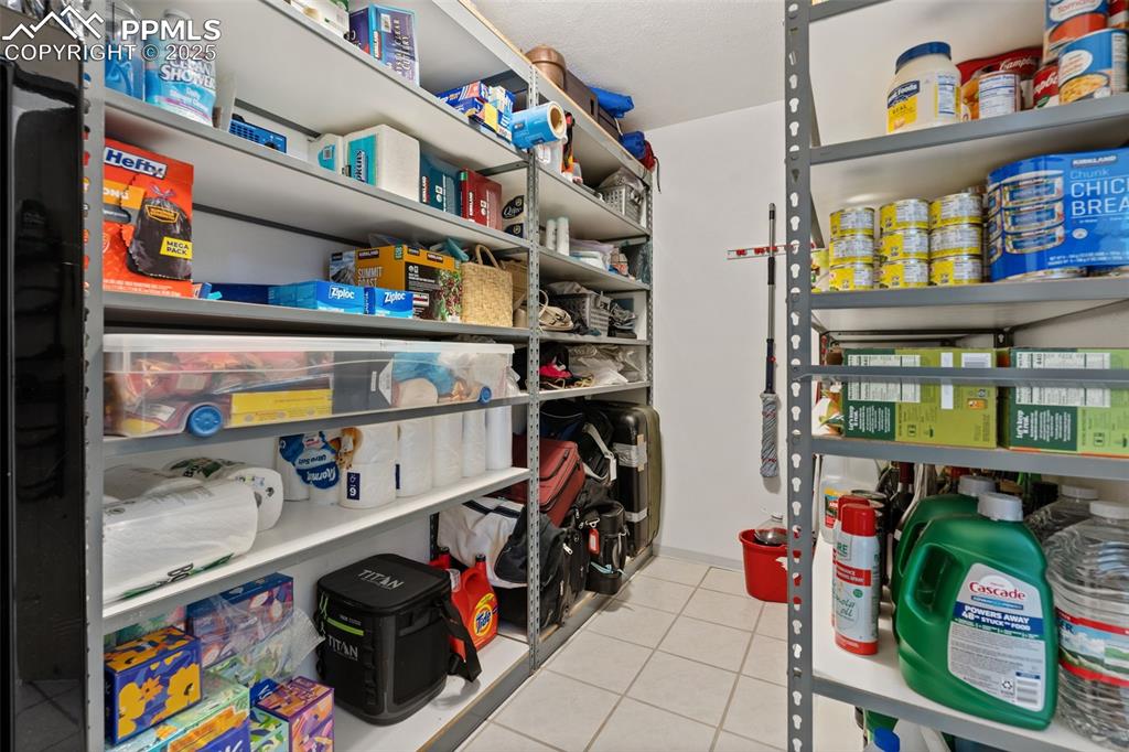 Image 34 of 45: Lower-Level Store Room with Included Storage Shelving!
