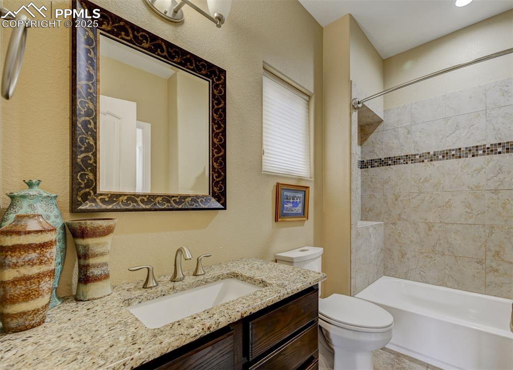 Image 19 of 30: Bathroom featuring vanity, washtub / shower combination, and toilet