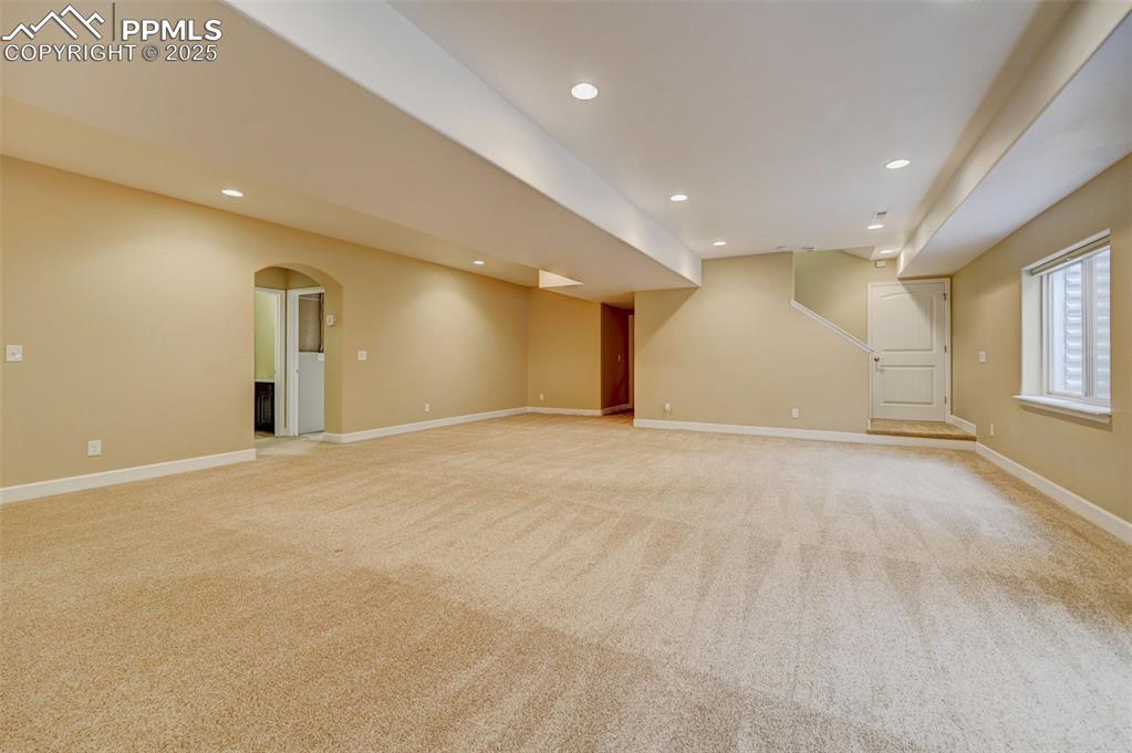 Image 22 of 30: Below grade area featuring light colored carpet, recessed lighting, and bas