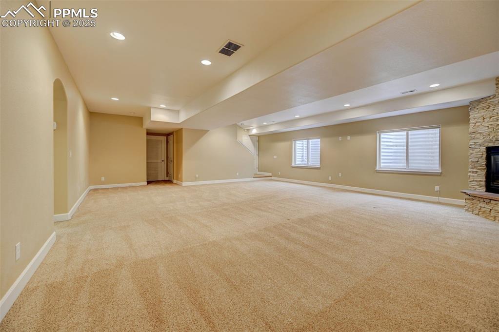 Image 23 of 30: Basement featuring light colored carpet, baseboards, visible vents, and rec