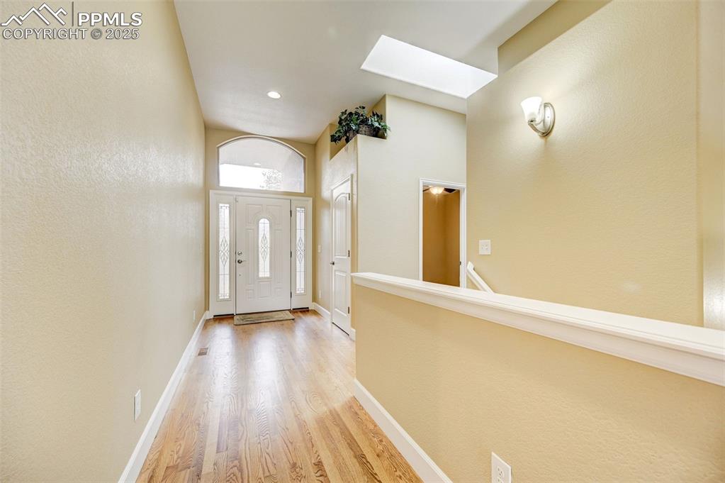 Image 3 of 30: Entryway with a skylight, baseboards, recessed lighting, and light wood-typ