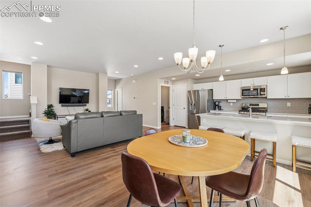 Image 16 of 29: Dining space featuring recessed lighting, a chandelier, light wood-type flo