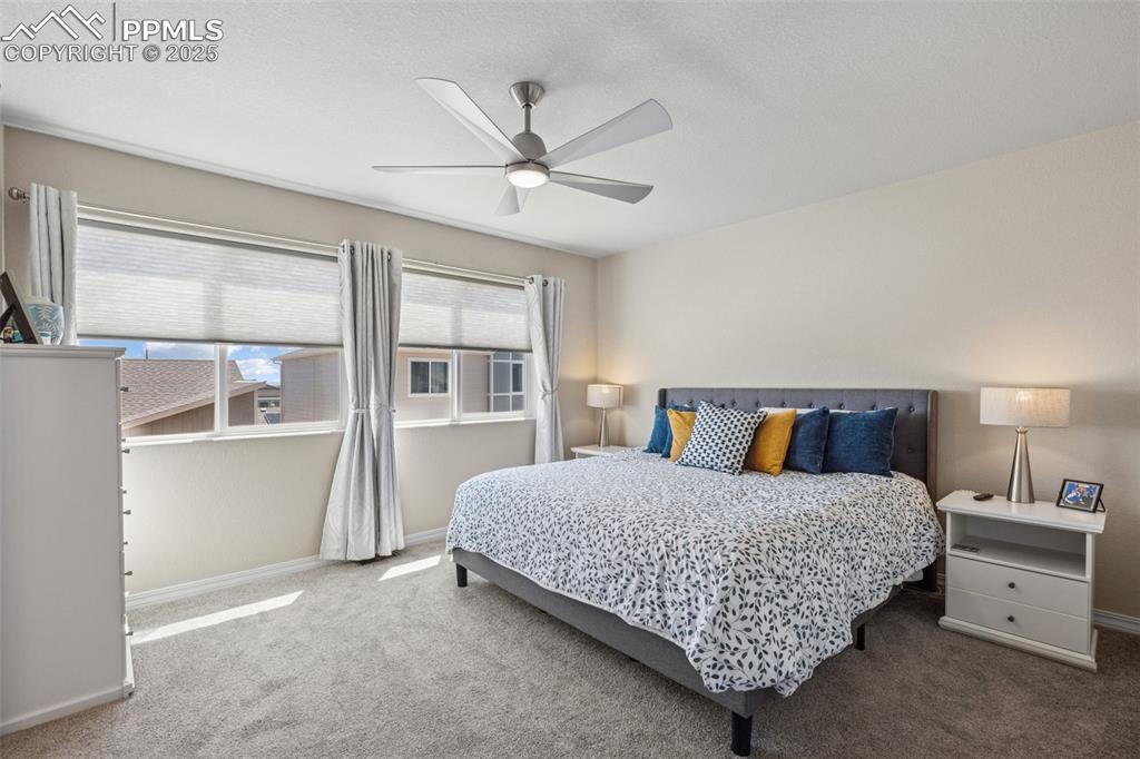 Image 27 of 29: Bedroom featuring carpet flooring, baseboards, and a ceiling fan