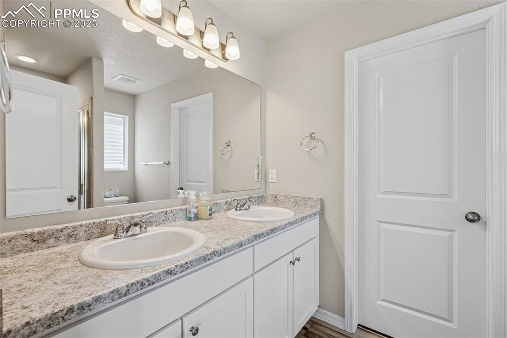 Image 29 of 29: Bathroom with double vanity and toilet
