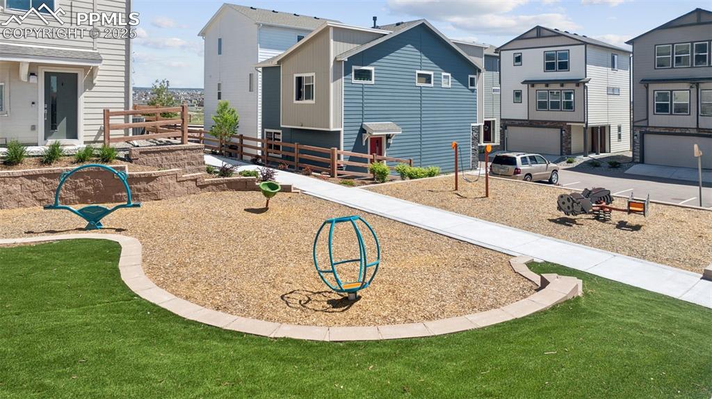 Image 9 of 29: View of community featuring an attached garage, a residential view, and dri
