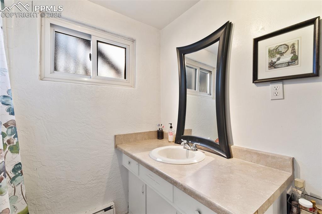 Image 16 of 49: Full bath featuring vanity and a shower with shower curtain