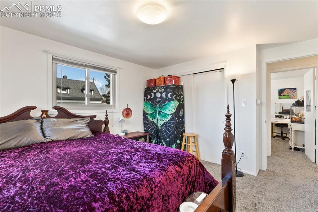 Image 20 of 49: Bedroom featuring a closet and light colored carpet