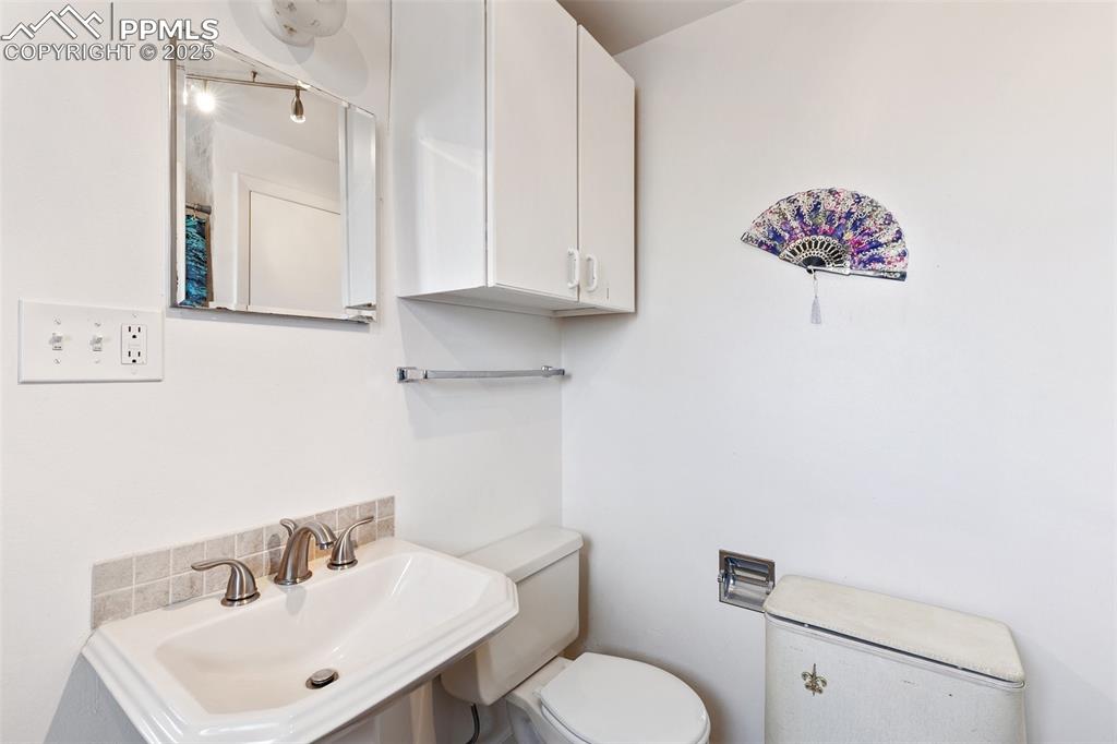 Image 22 of 49: Bathroom featuring toilet and a sink