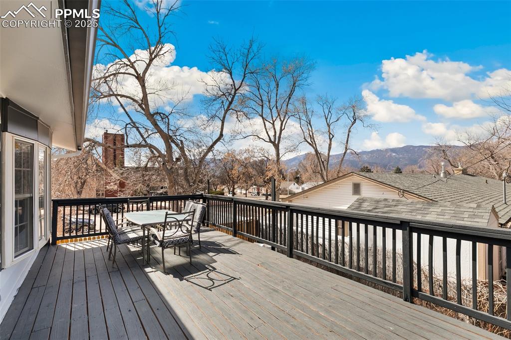 Image 31 of 49: Deck featuring outdoor dining space and a mountain view