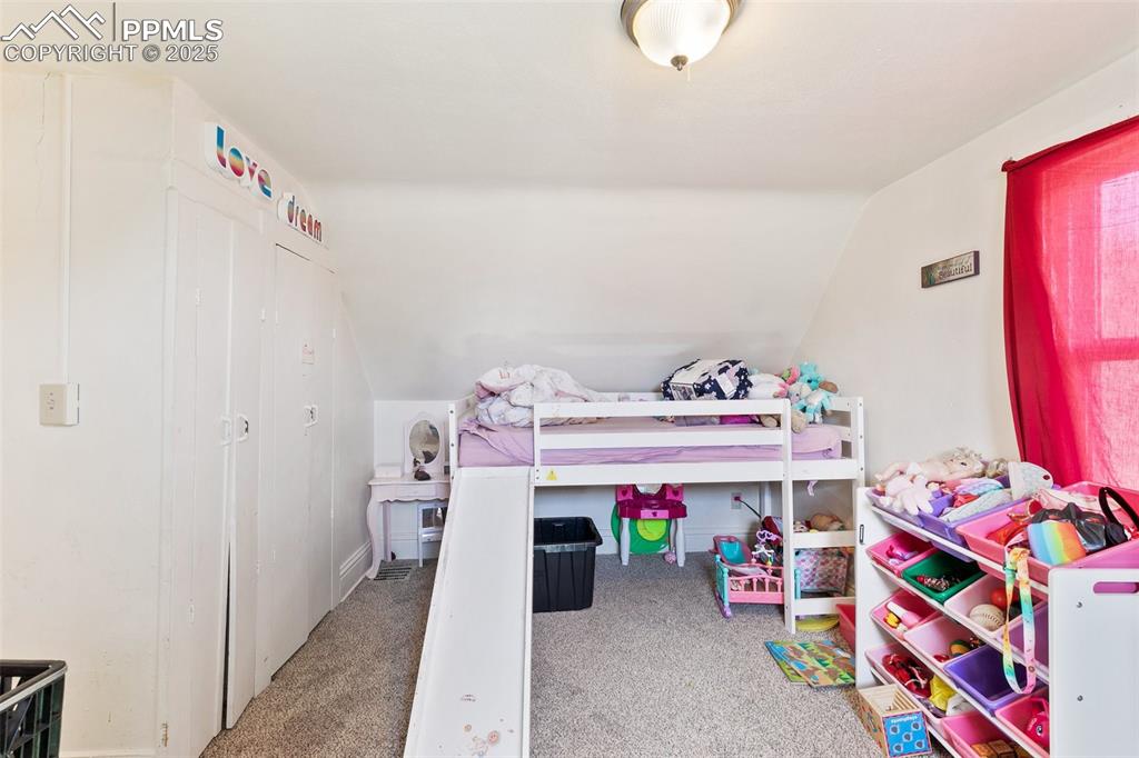 Image 45 of 49: Carpeted bedroom featuring vaulted ceiling