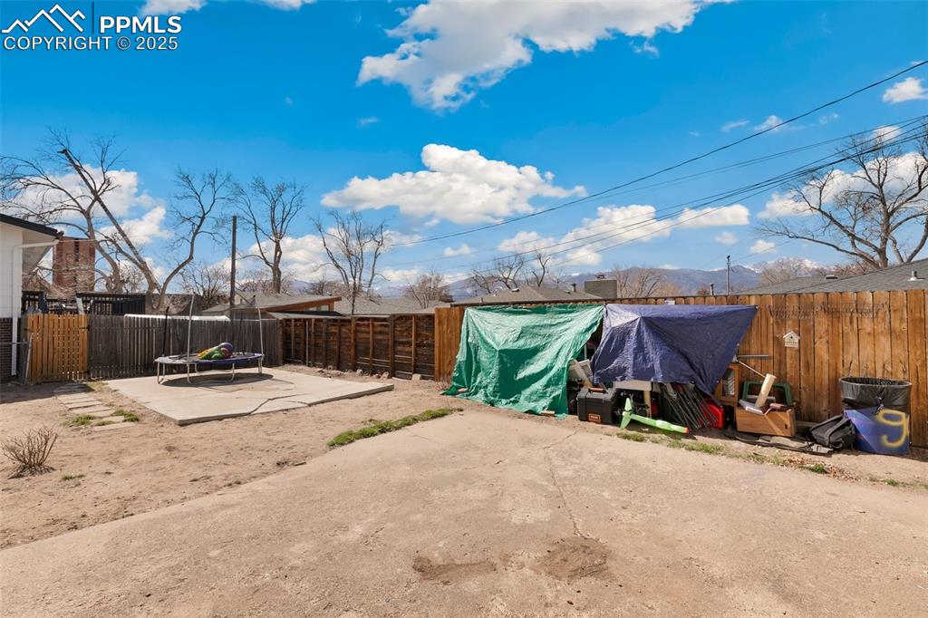 Image 49 of 49: View of yard featuring a patio and a fenced backyard