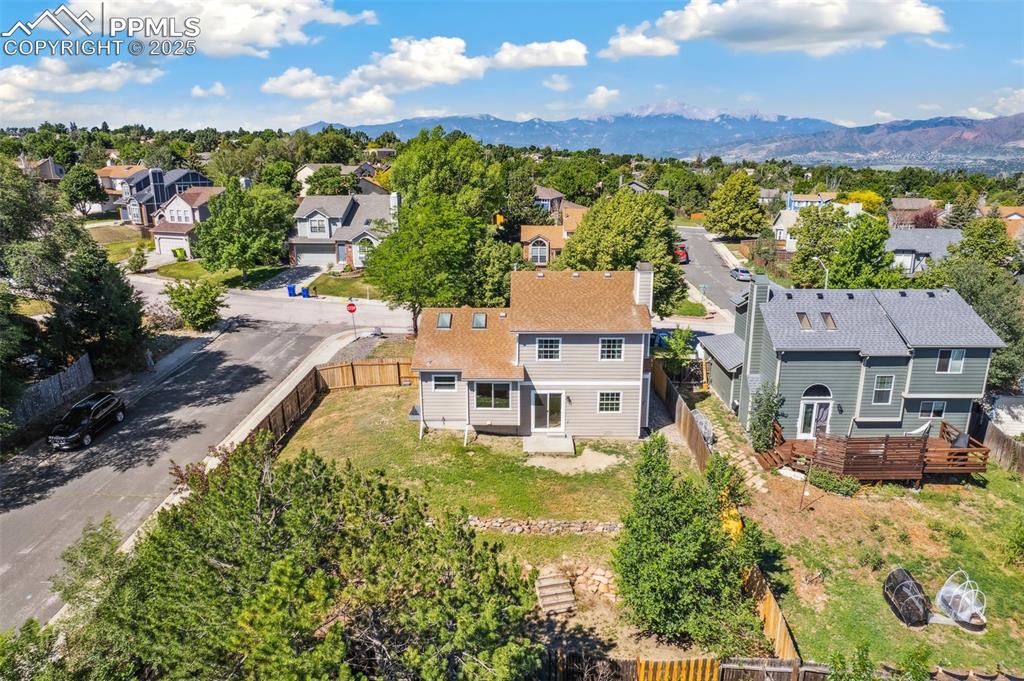 Image 22 of 22: Aerial view of residential area with a mountain backdrop