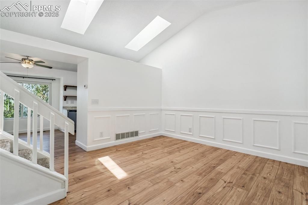 Image 3 of 22: Spare room featuring a skylight, light wood finished floors, stairs, lofted