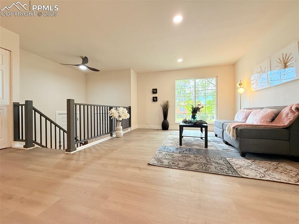 Image 10 of 50: Sitting room featuring an upstairs landing, recessed lighting, and light wo