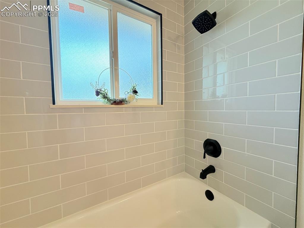 Image 25 of 50: Full bathroom with shower / bath combination