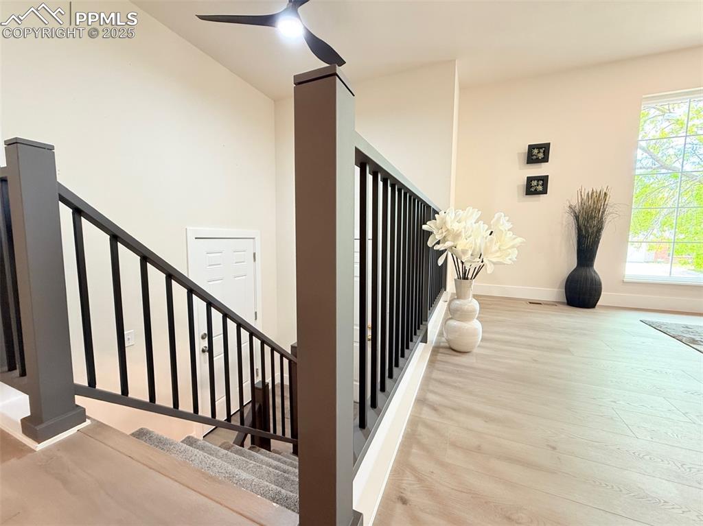 Image 31 of 50: Staircase featuring wood finished floors and a ceiling fan