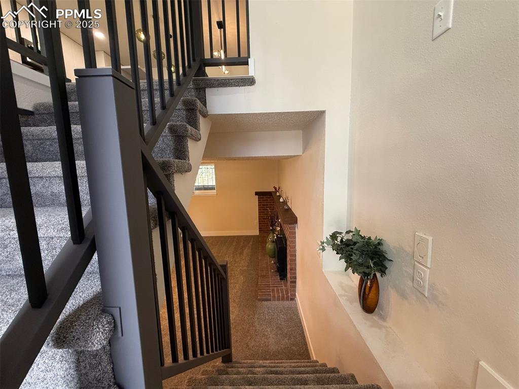 Image 34 of 50: Staircase with carpet flooring