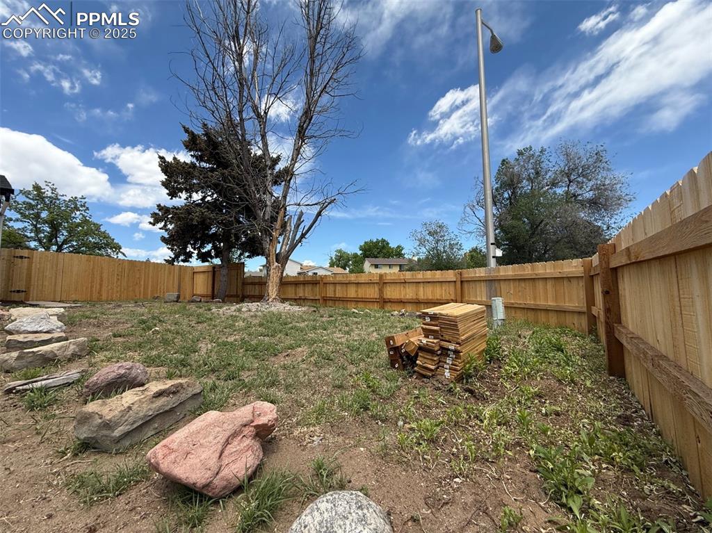 Image 50 of 50: View of fenced backyard