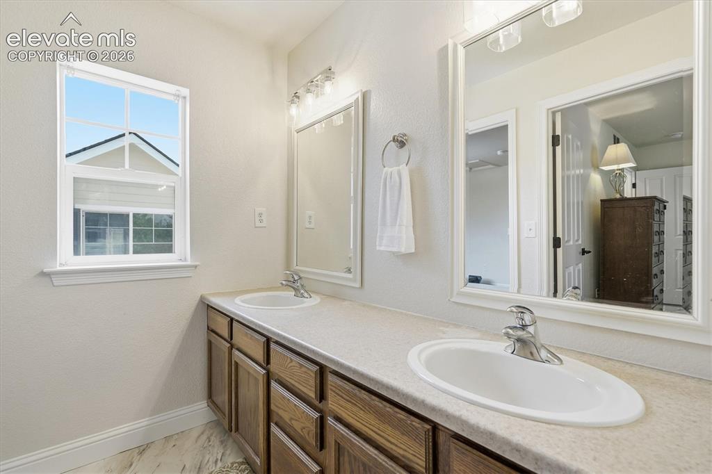 Image 38 of 50: Jack & Jill Bathroom with dual sinks