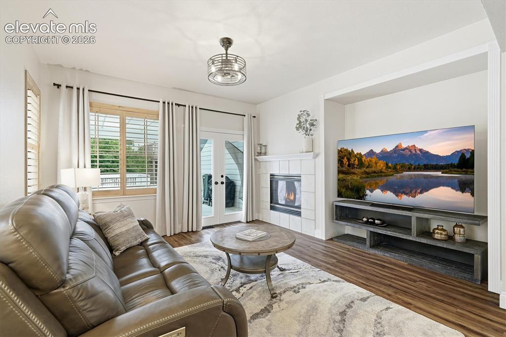 Image 4 of 50: Spacious great room w/ gas fireplace & French doors