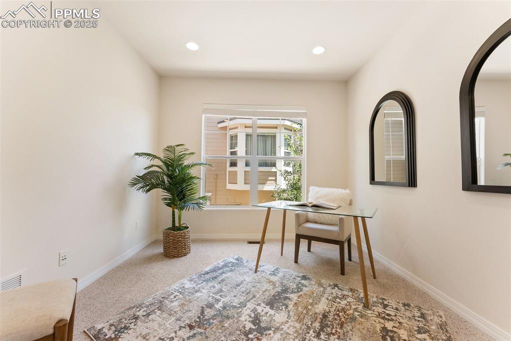 Image 13 of 48: Carpeted office space featuring arched walkways and recessed lighting