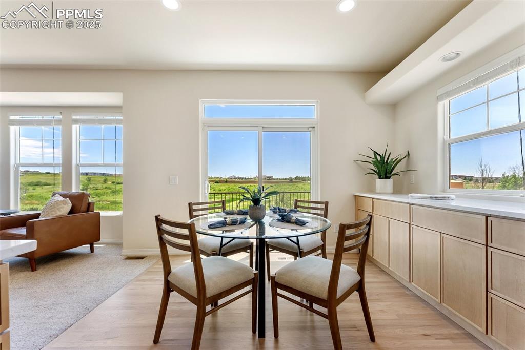 Image 19 of 48: Dining room with recessed lighting and light wood-style flooring