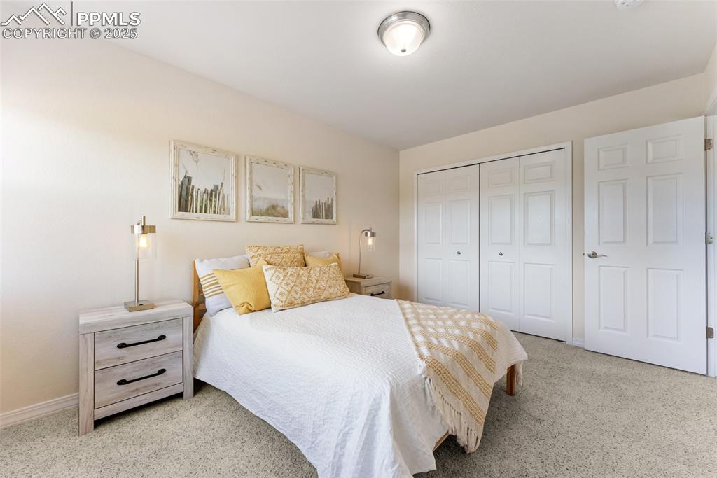 Image 23 of 48: Bedroom with carpet floors and a closet