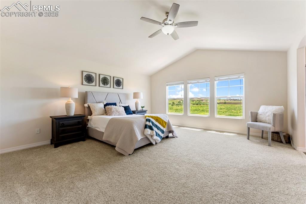Image 25 of 48: Bedroom with carpet, lofted ceiling, and ceiling fan