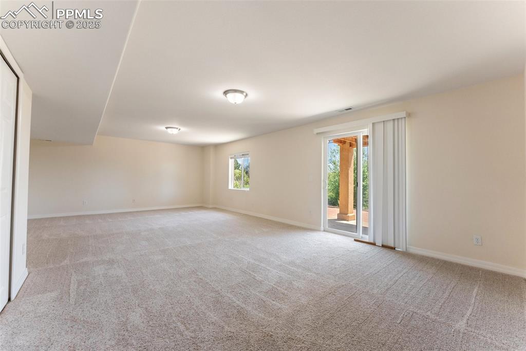 Image 33 of 48: Carpeted empty room featuring baseboards