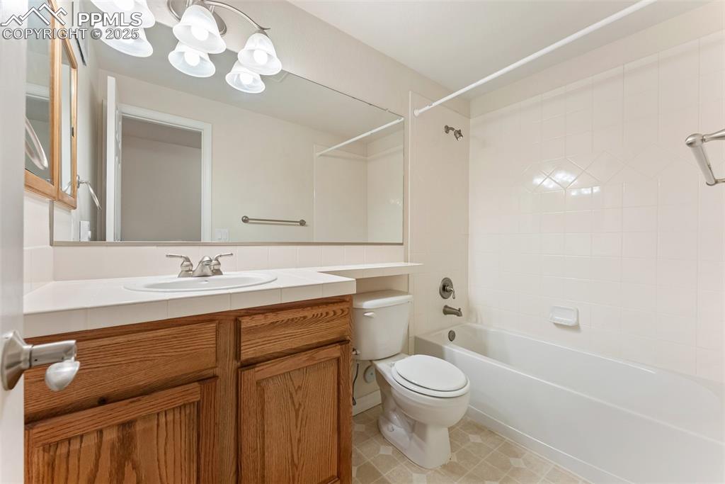 Image 36 of 48: Full bathroom featuring vanity, bathing tub / shower combination, and tile