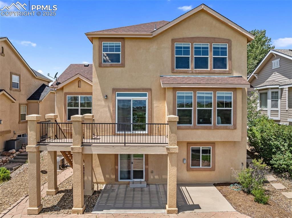 Image 43 of 48: View of front of property with stucco siding, a patio area, roof with shing