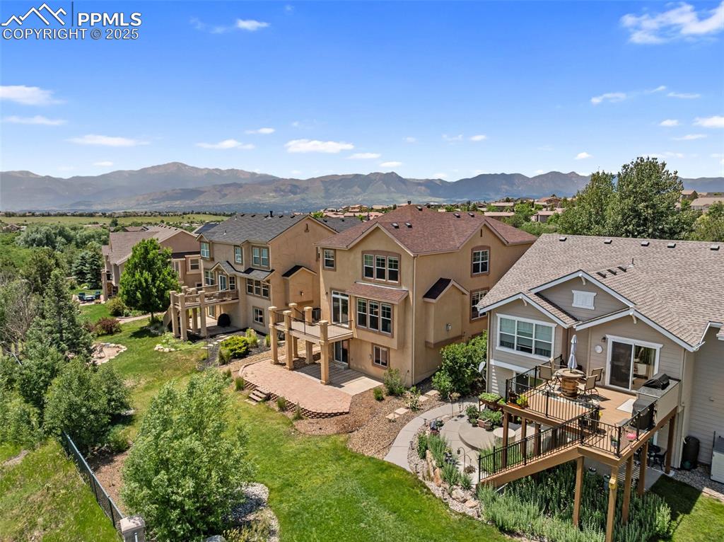 Image 45 of 48: Aerial perspective of suburban area with a mountain backdrop