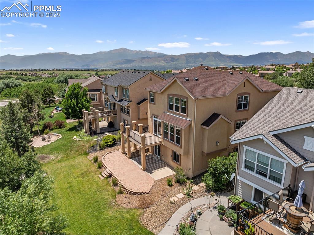 Image 46 of 48: Aerial perspective of suburban area with a mountain backdrop
