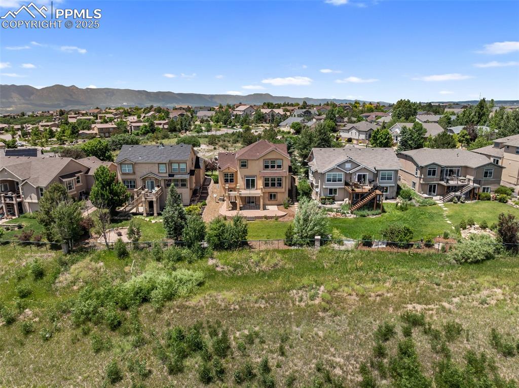 Image 47 of 48: Aerial perspective of suburban area featuring mountains