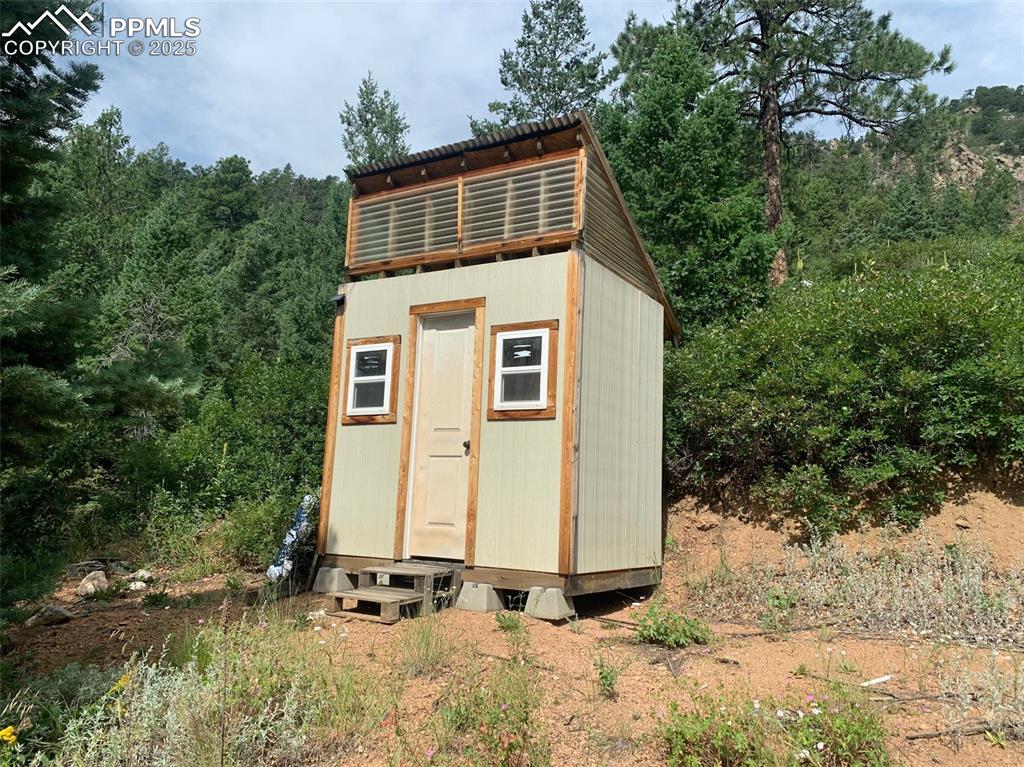 Image 9 of 16: Small bathhouse with composing toilet and shower pan