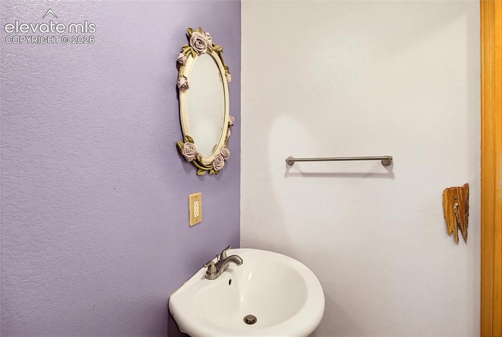 Image 21 of 47: Powder room off Dining area