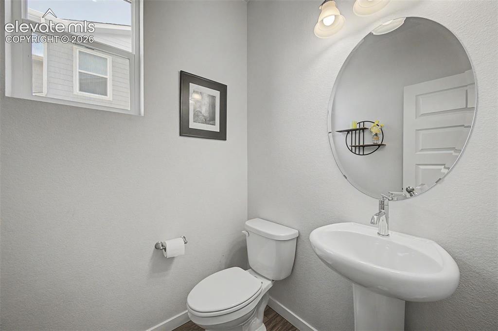 Image 15 of 45: A convenient main floor powder room is accessible from the foyer.