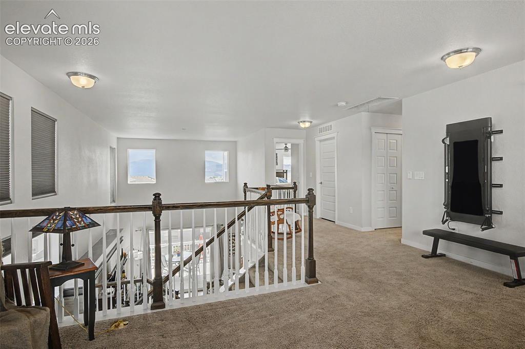 Image 19 of 45: View of upper level hallway from loft.