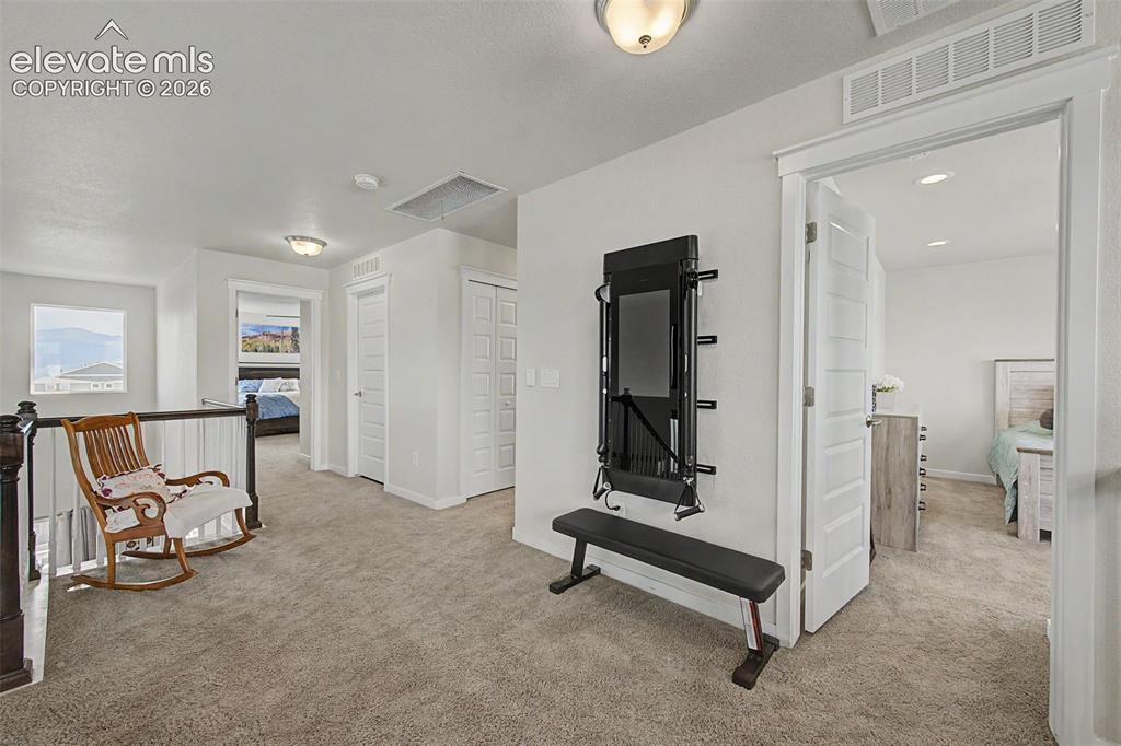 Image 20 of 45: View of upper level hallway from loft.