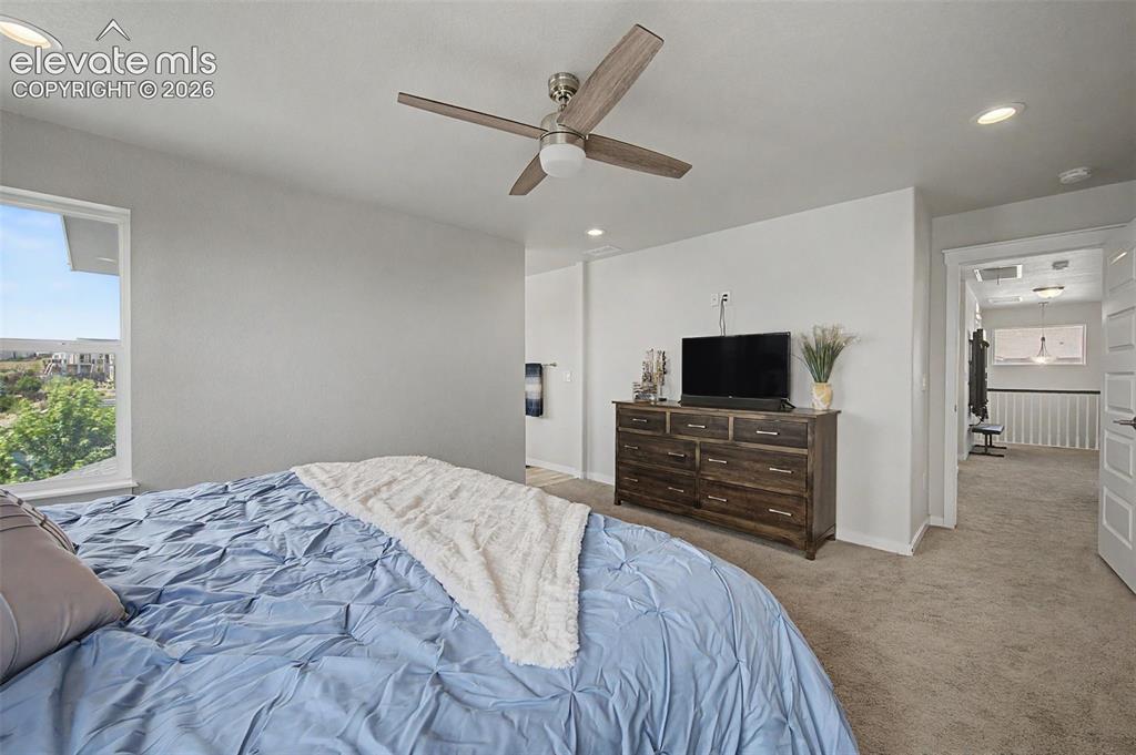 Image 22 of 45: The upper level primary suite will be your private retreat.
