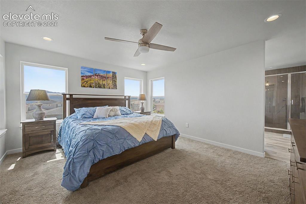 Image 24 of 45: The spacious primary bedroom leads into an awesome 5-pc bath.