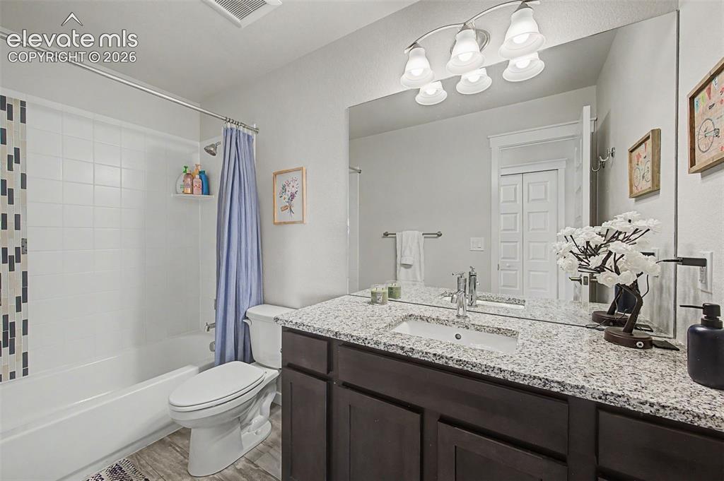 Image 33 of 45: The upper level full hall bath features a granite vanity.