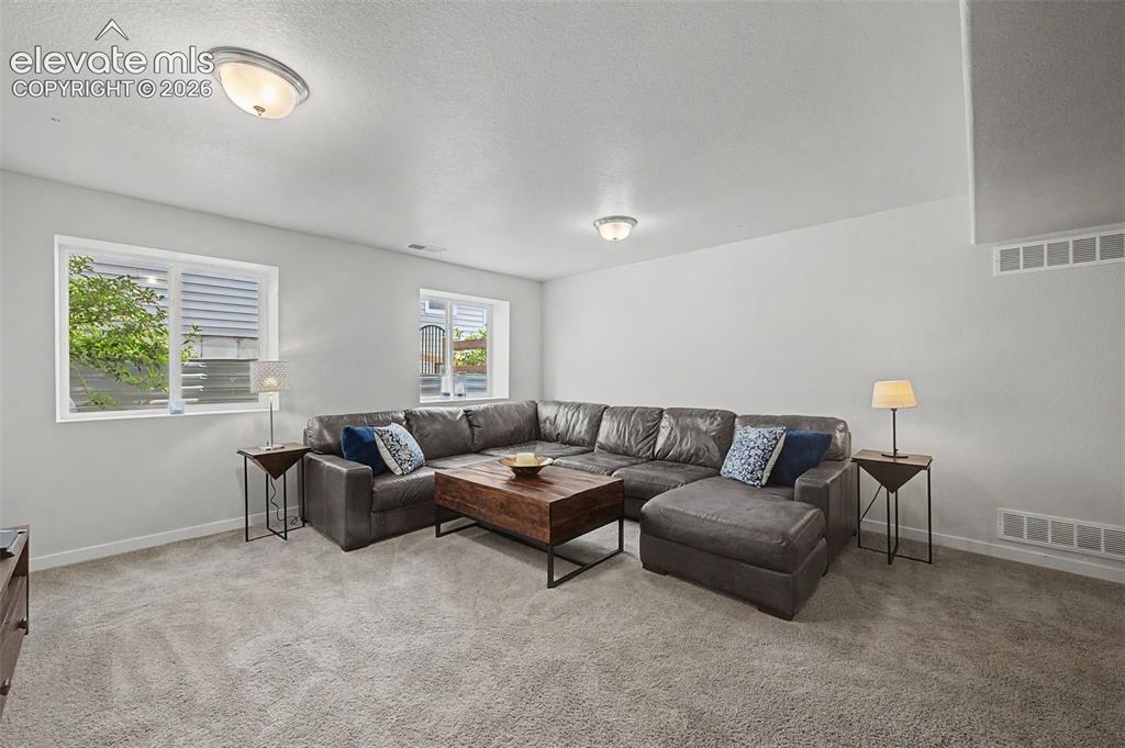 Image 35 of 45: The garden level basement family room is open and bright.