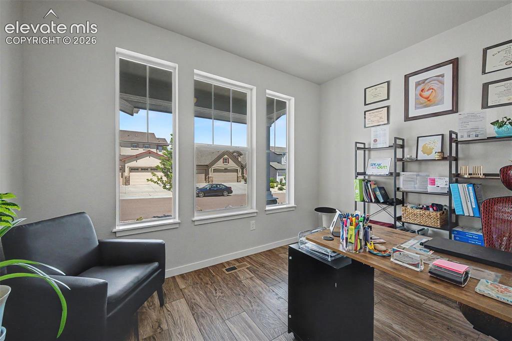 Image 4 of 45: A private office is located adjacent to the front foyer.