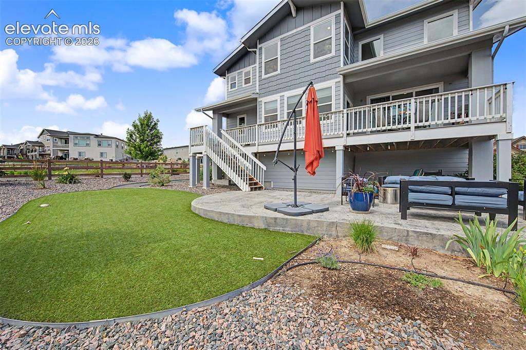 Image 42 of 45: This home offers a beautifully landscaped backyard, a spacious patio and an