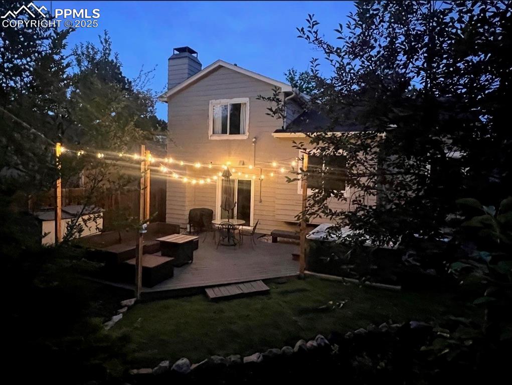Image 33 of 41: Rear view of property with a wooden deck,and hot tub