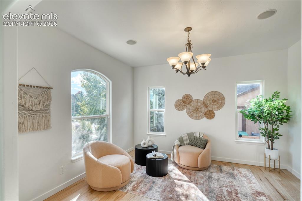 Image 10 of 49: Recessed ceiling lighting, a five-light chandelier, archway detailing, wood