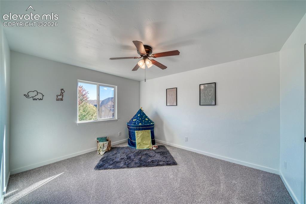 Image 30 of 49: Neutral wall paint, ceiling fan with integrated lighting, carpeted flooring