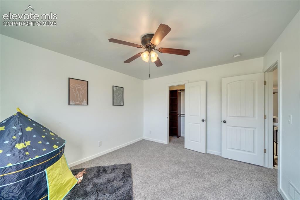 Image 31 of 49: Carpeted flooring, white walls, ceiling fan with integrated lighting, two-p